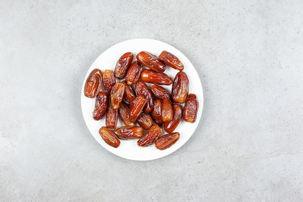 A platter of fresh dates on marble surface