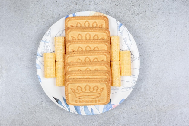 A platter with arranged biscuits on marble background. High quality photo