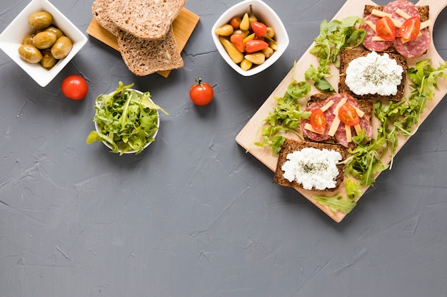 Platter with sandwiches and vegetables with copy space