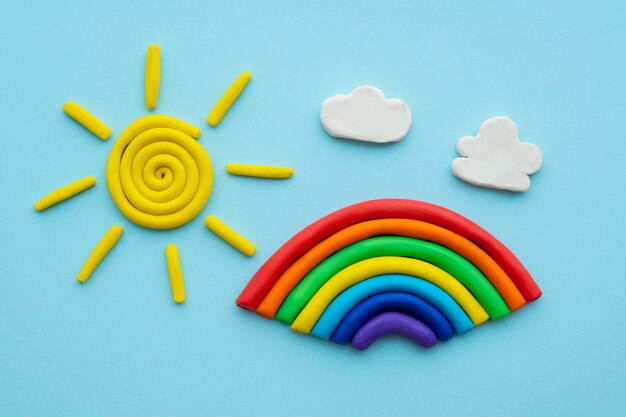 Play dough background with rainbow and sun