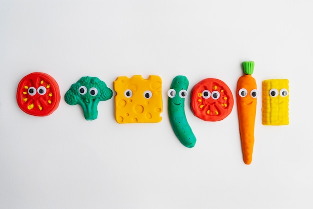 Play dough background with vegetables top view