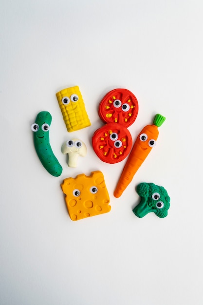 Play dough background with vegetables above view