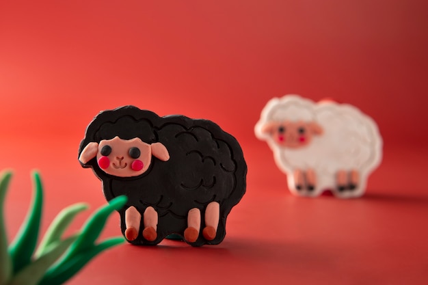 Free photo playdough art with black and white sheep