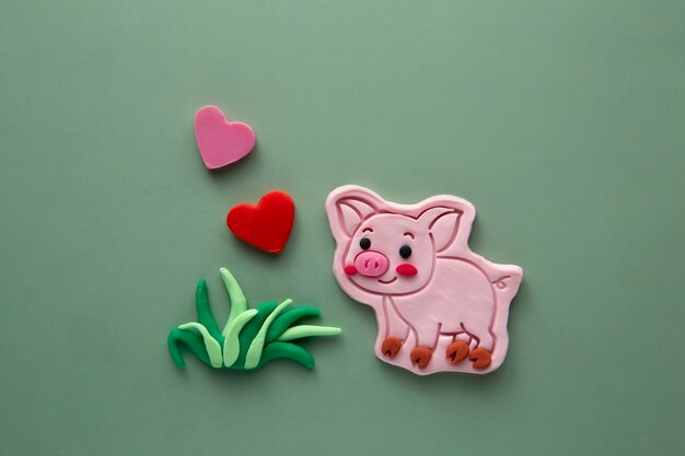 Playdough art with cute pig and grass