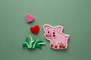 Free photo playdough art with cute pig and grass