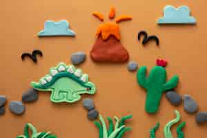 Бесплатное фото Искусство пластилина с динозавром и вулканом