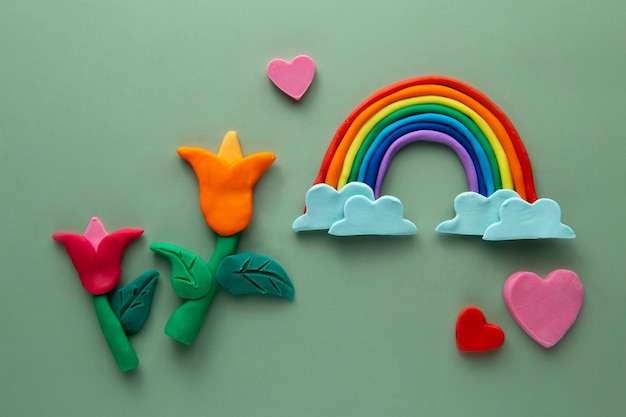 Free photo playdough art with flowers and rainbow