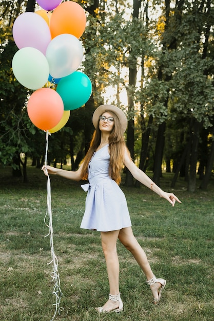 Playful birthday woman with balloons