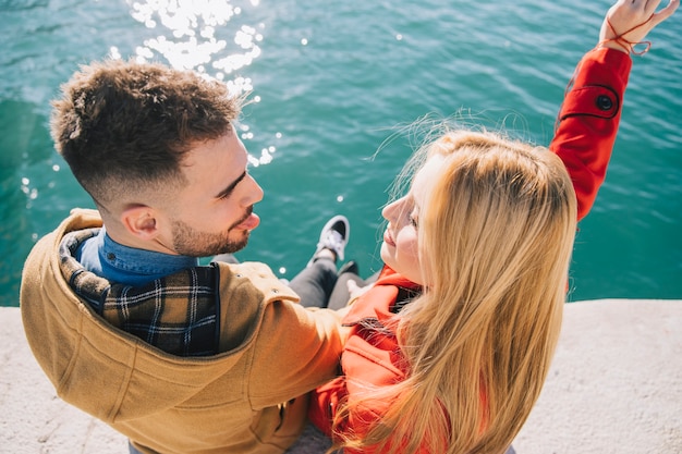 Playful content couple on pier