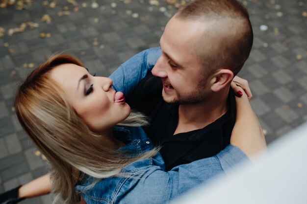 Playful couple embracing on street