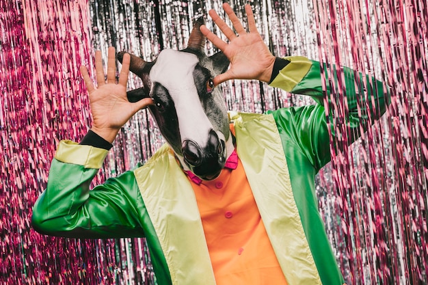 Playful cow costumated male for carnival party