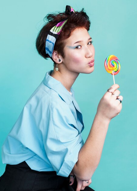 Playful female model posing with lollipop