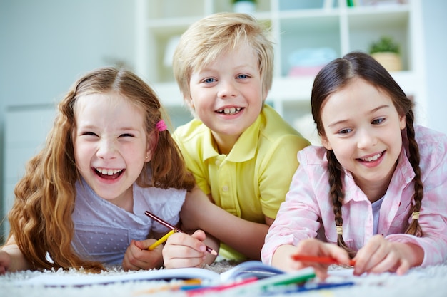 Playful friends drawing together