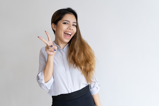 Playful girl gesturing peace