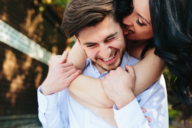 Playful girlfriend licking her boyfriend's ear