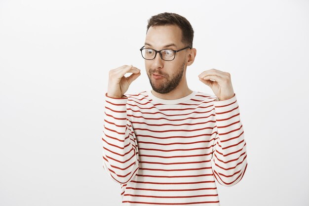 playful insane adult guy in black glasses, talking with hands