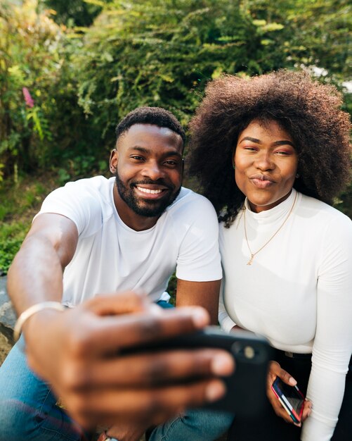 Playful intercultural friends taking selfie