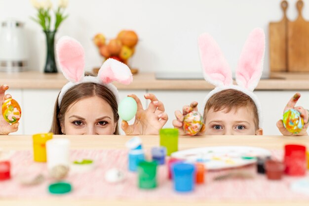 Playful mom and son with rabbit ears