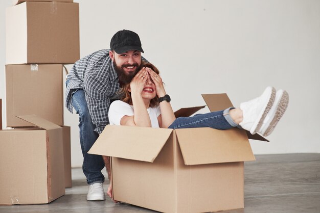 Playful mood. Happy couple together in their new house. Conception of moving