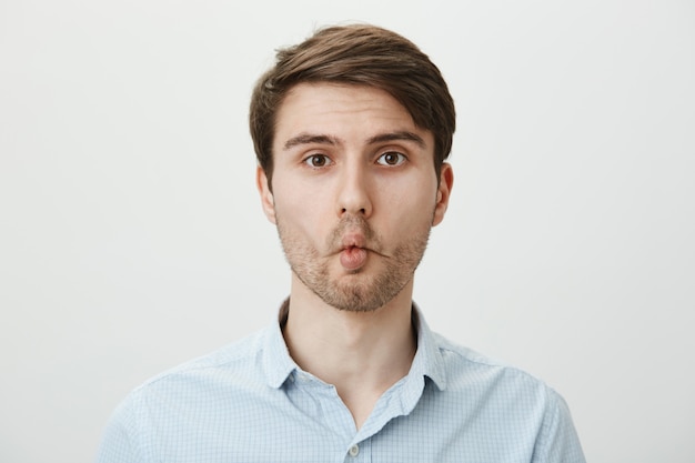 Free photo playful silly man with fishy lips aping