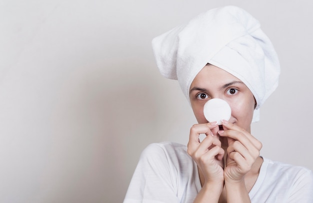 Free photo playful woman holding makeup disc