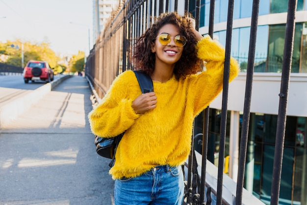 Playful woman looking in camera and standing outdoor.