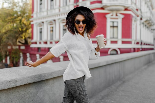 Playful woman wraps herself over her shoulder