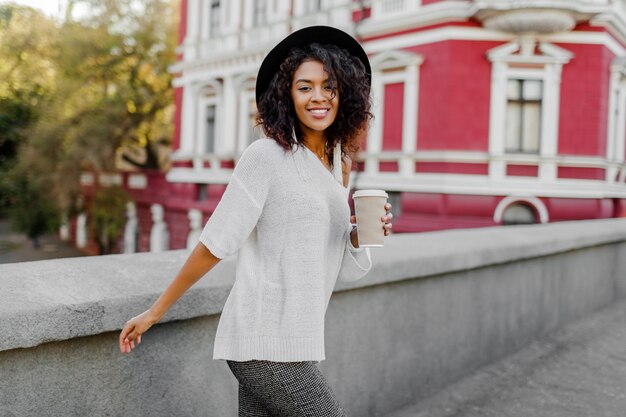 Playful woman wraps herself over her shoulder