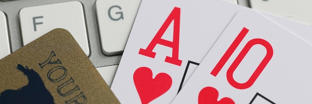 Playing cards bank credit card and computer keyboard on table online gambling concept