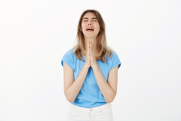 Pleading woman begging for help or praying desperate