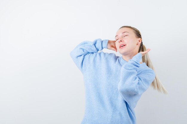 The pleasant girl is dancing on white background