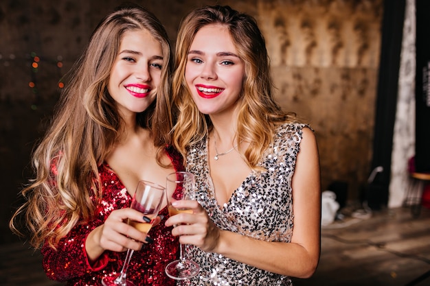 Pleasant ladies enjoying champagne at christmas event