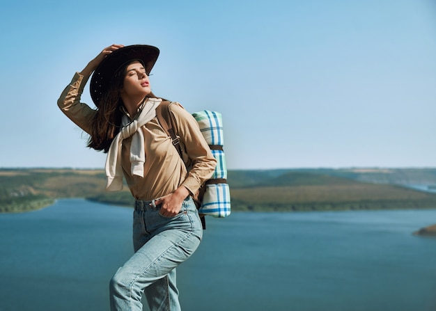 Pleasant woman enjoying sunny weather at the lake