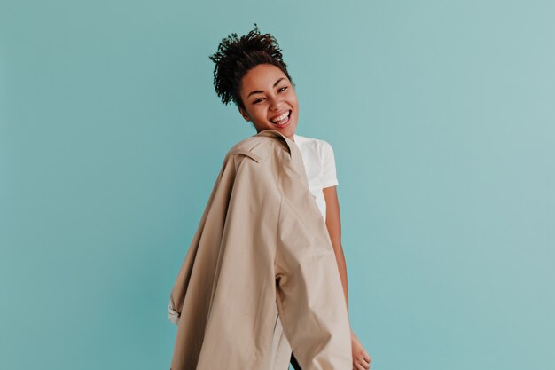 Pleasant woman holding trench coat