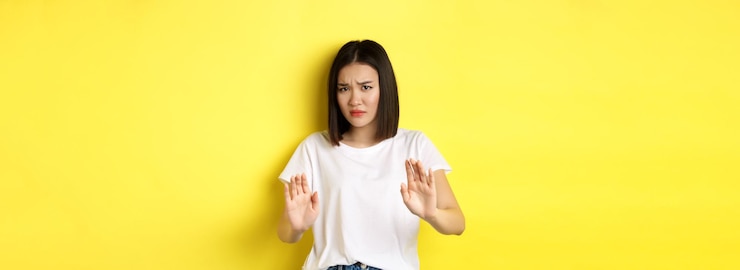 Free Photo please no asian woman victim of assualt or domestic abuse pleading with hands raised up in defense f