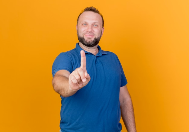 Pleased adult slavic man raising finger isolated