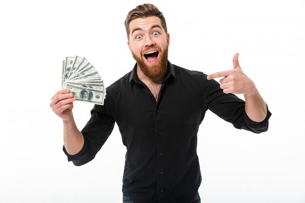 Pleased bearded business man in shirt holding money