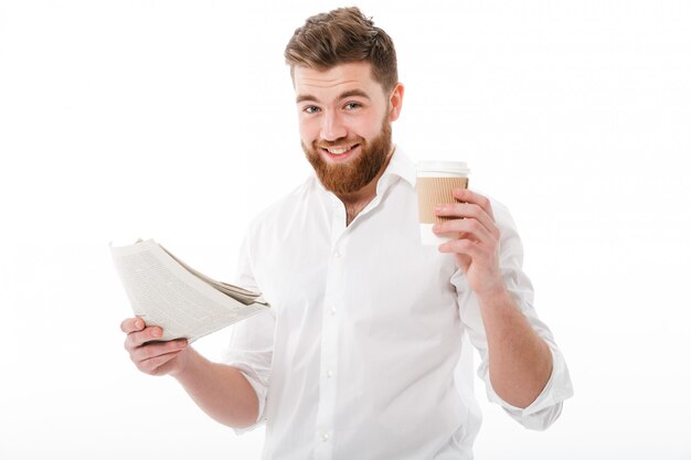 Pleased bearded man in business clothes holding newspaper