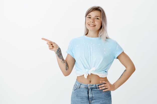 Pleased blonde girl posing in the studio