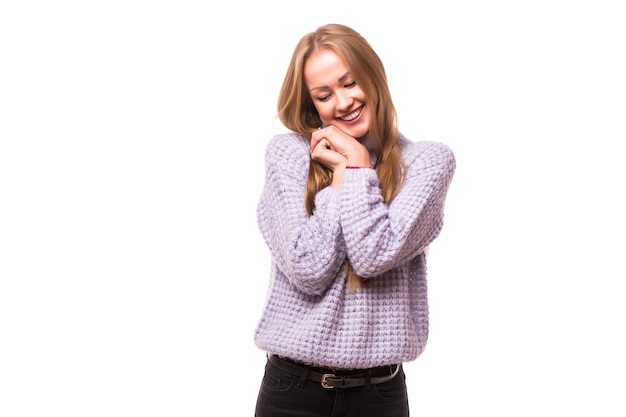 Pleased brunette woman reclines on her hands  over white wall