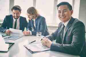 Free photo pleased businessman with annual report