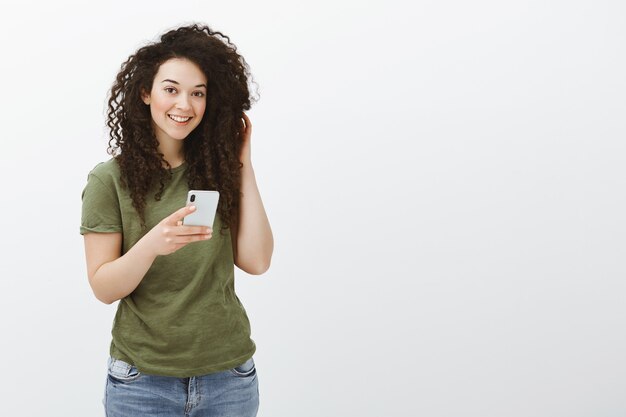 Pleased carefree good-looking woman with curly hair