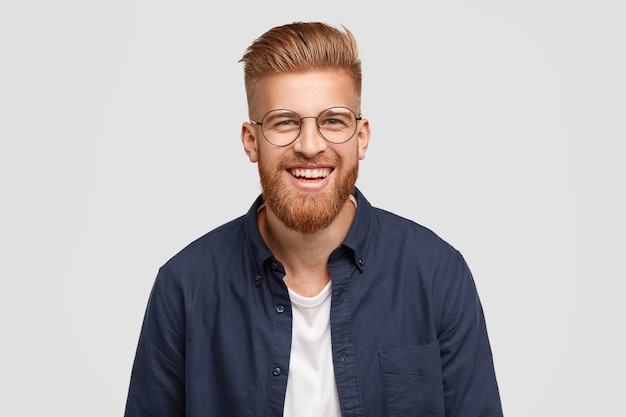 Pleased cheerful redhaired male with pleasant smile