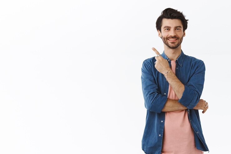 Free Photo pleased confident goodlooking bearded man in tshirt shirt pointing upper left corner smiling satisfied and amused give advice proudly showing friend where christmas gifts hidden from family