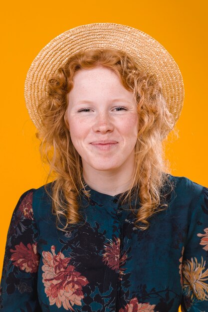 Pleased curly redhead female in studio