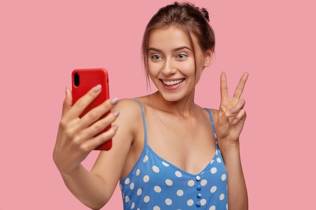 Pleased European girl with toothy smile