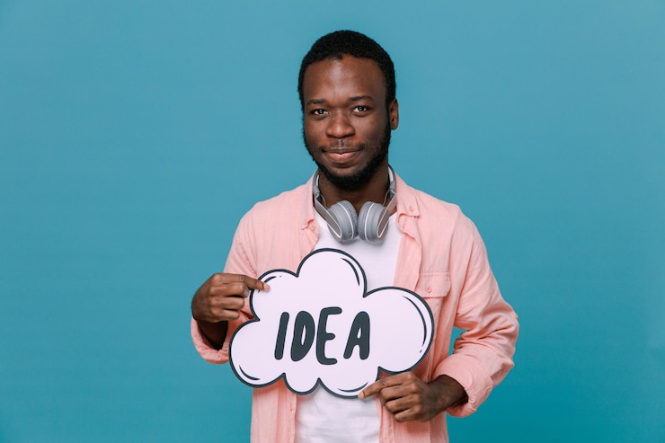 Free Photo pleased holding idea bubble young africanamerican guy wearing headphones on neck isolated on blue background