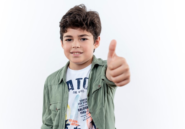 Pleased little schoolboy his thumb up isolated on white background