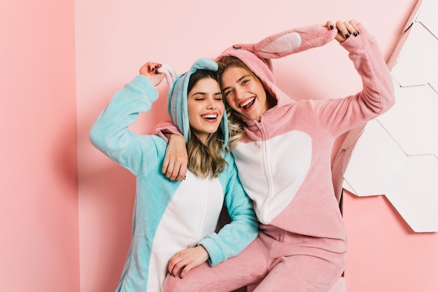 Pleased women posing in kigurumi