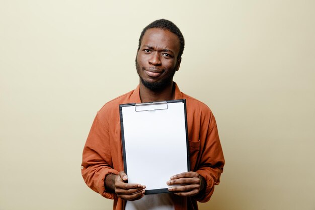 pleased young african american male holding clipboard isolated on white background